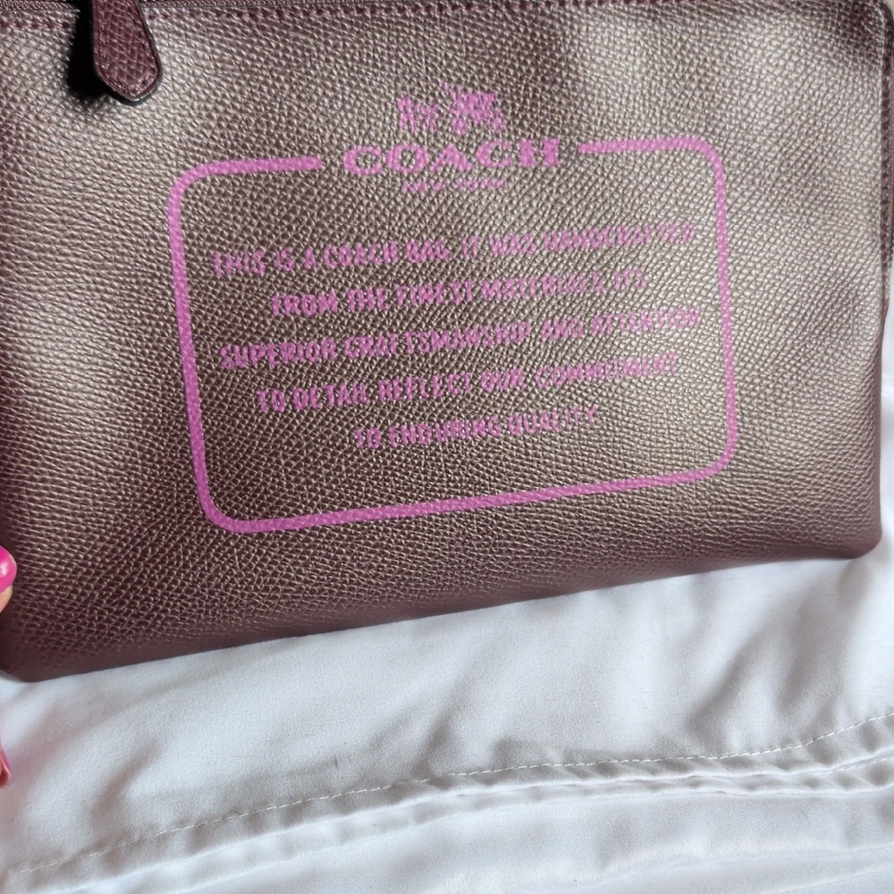 COACH Plum Leather Wristlet with Pink Logo Print